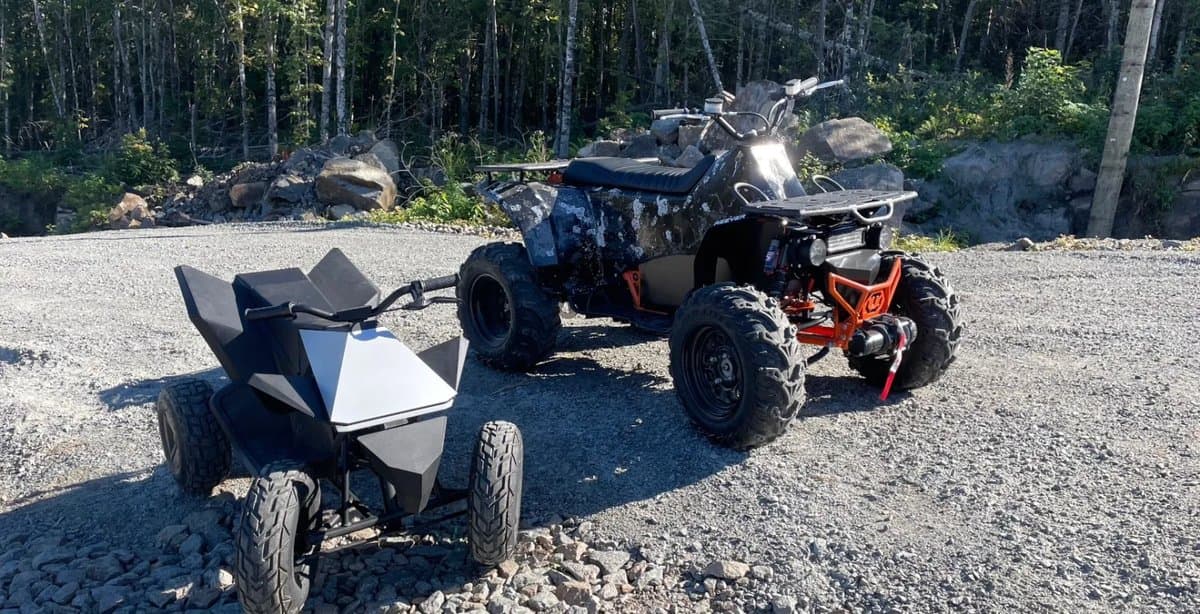 Reever electric ATV with trailer attachment on a gravel trail